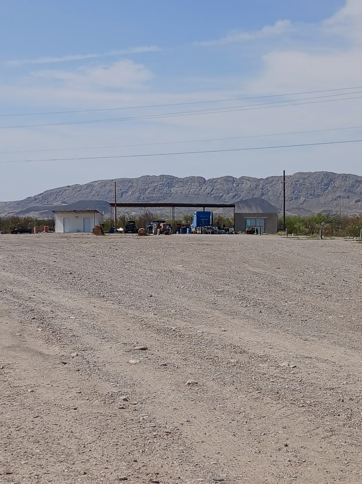 Gravel RV lot with mountains behind it